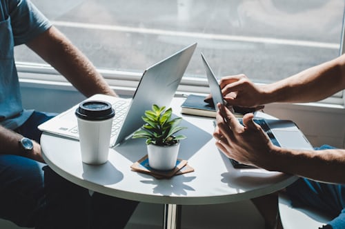Two professionals reviewing work together at a table